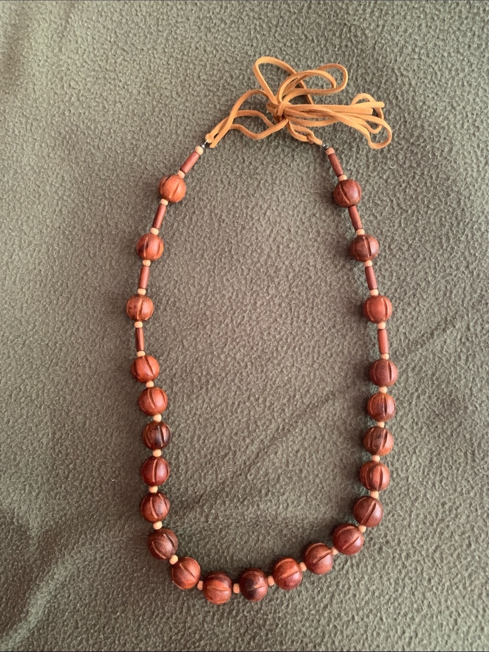 Boho leather and wood bead necklace. Adjustable leather ties. Approx 47”